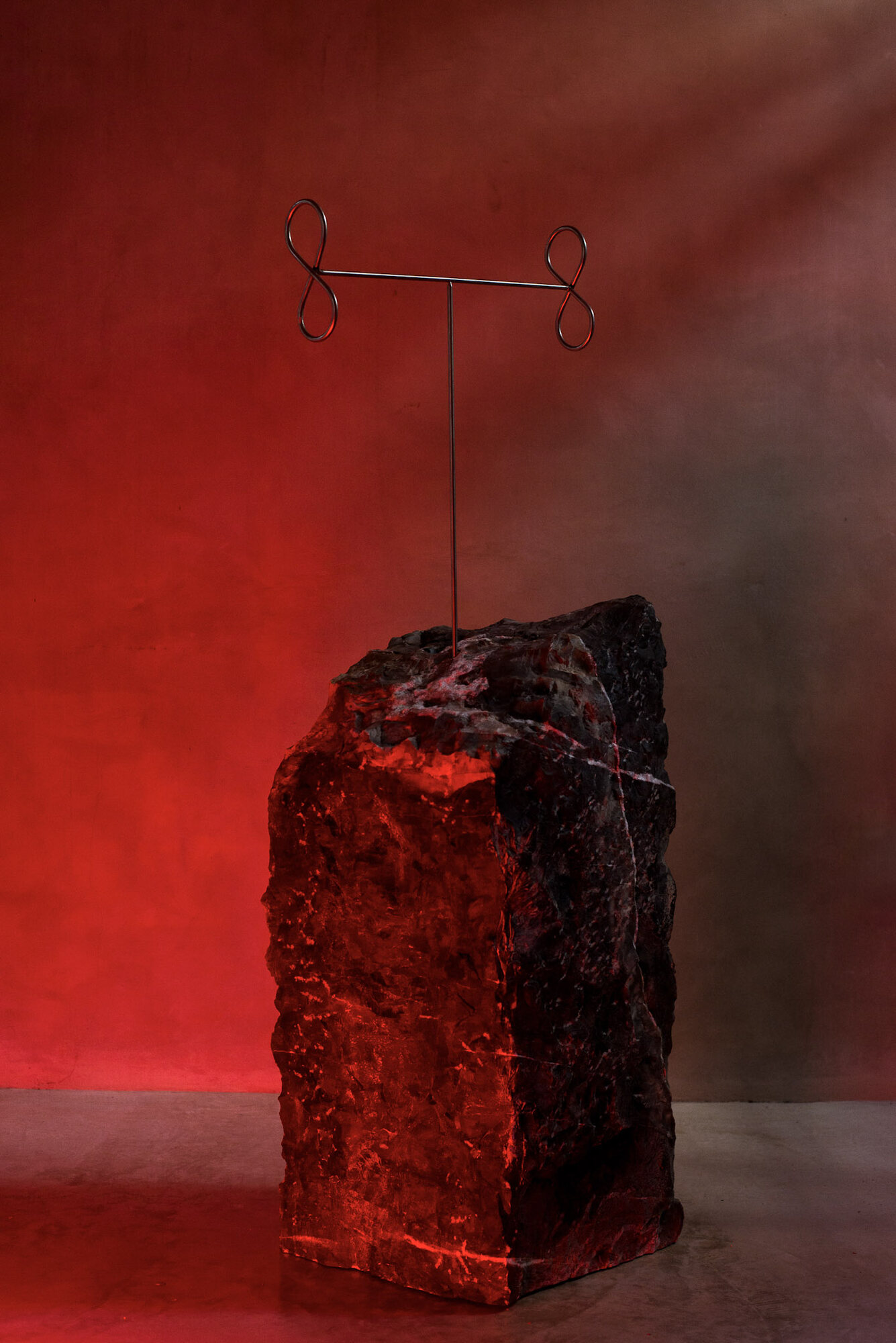 Sculpture in a studio lit deep red