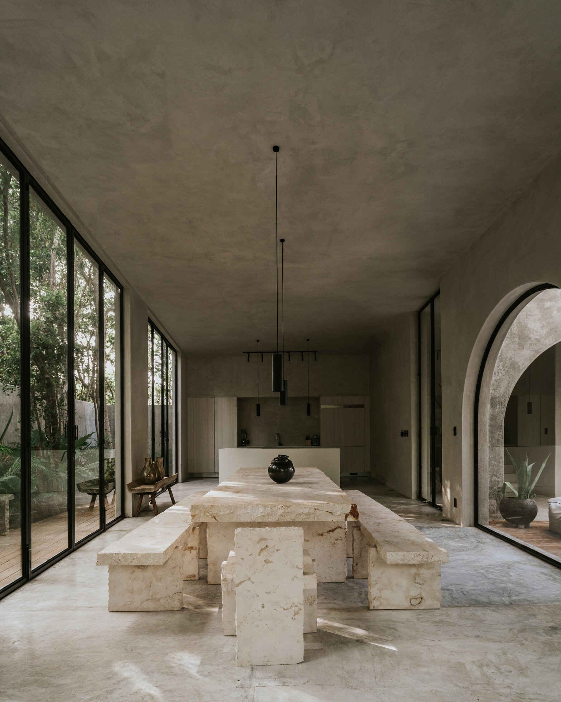 Head-on view of the set under a plaster ceiling, kitchen and arched opening behind