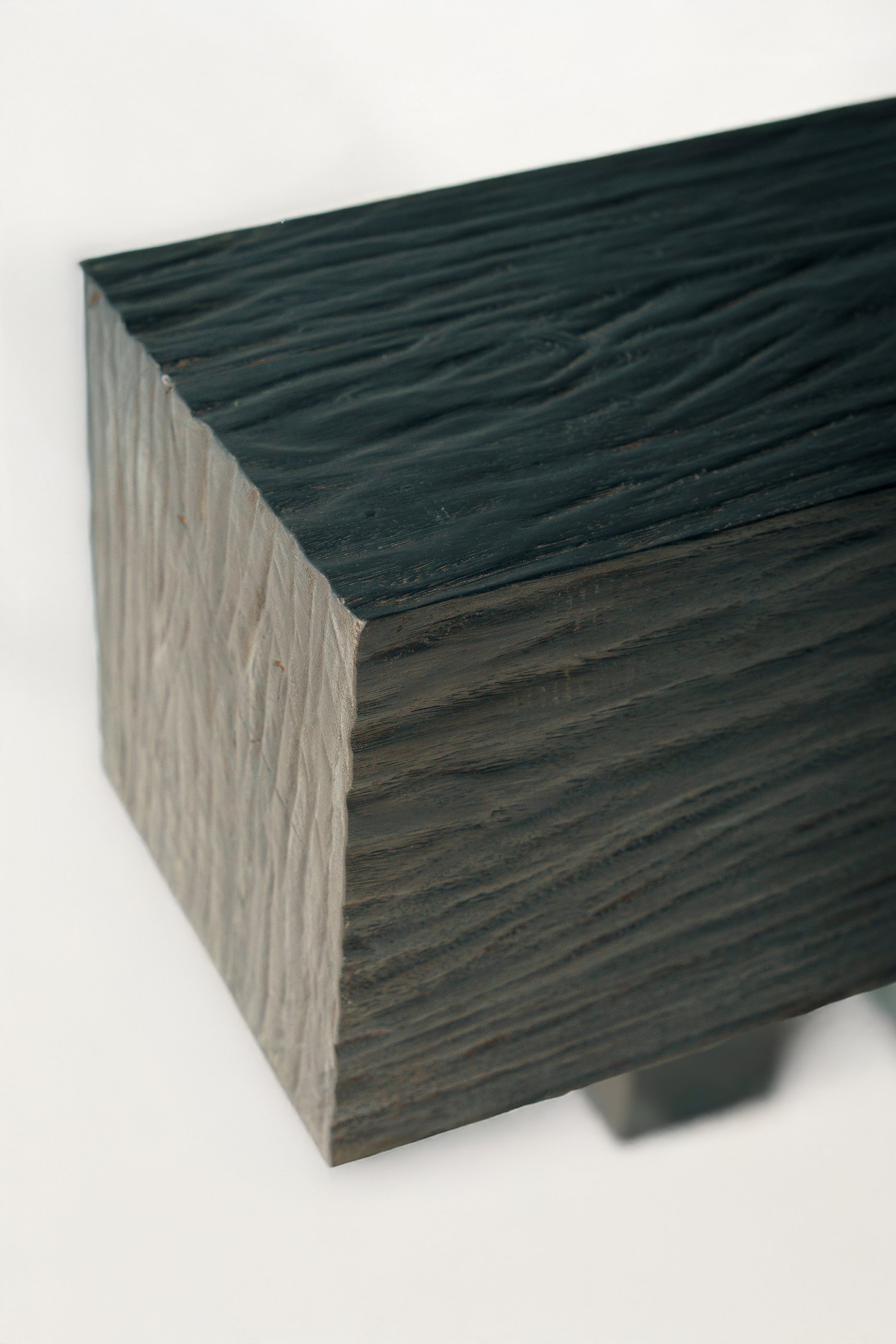 Corner of the bench, carved ridges on the top and end grain