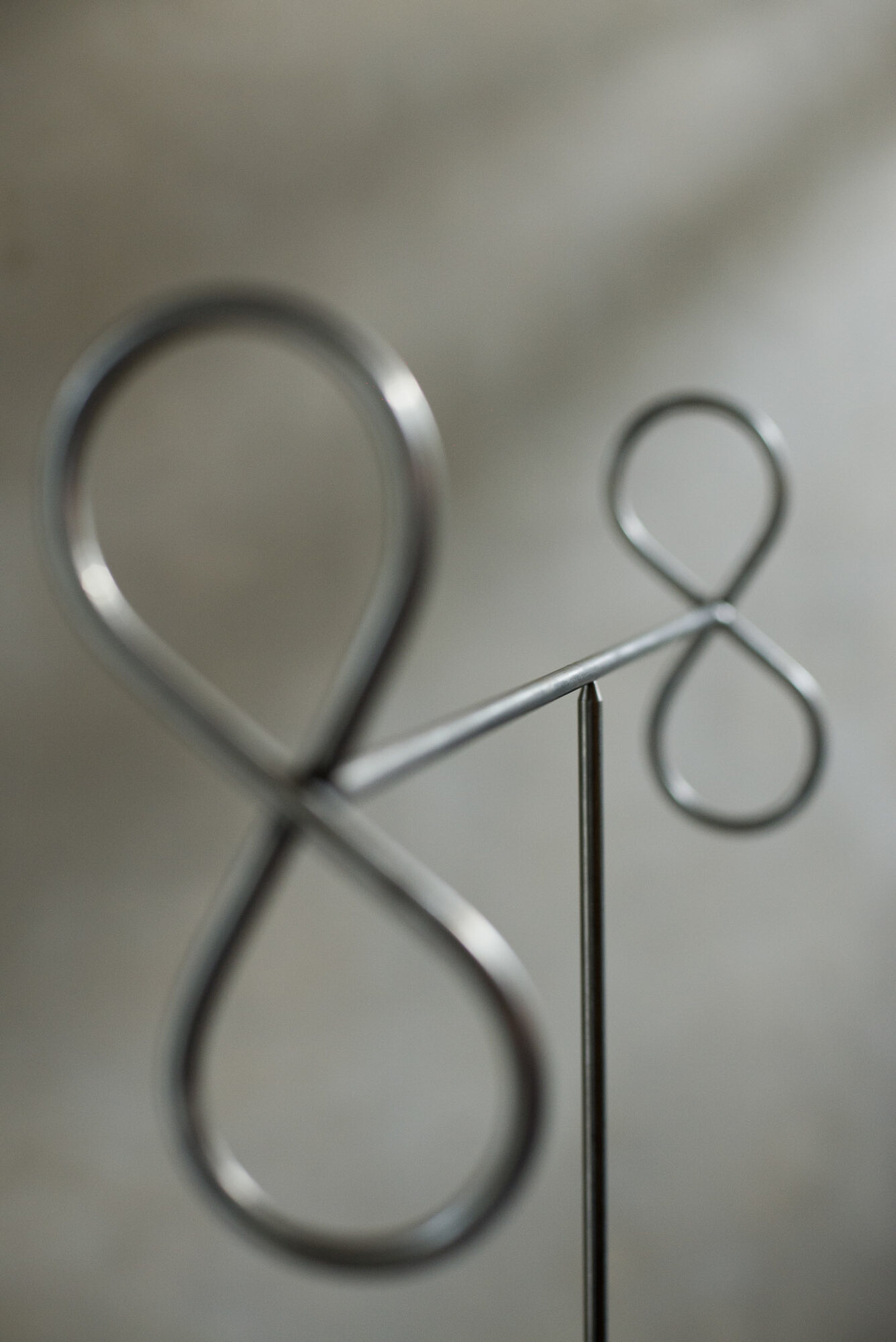Close view of two steel figure-eight loops joined by a bar